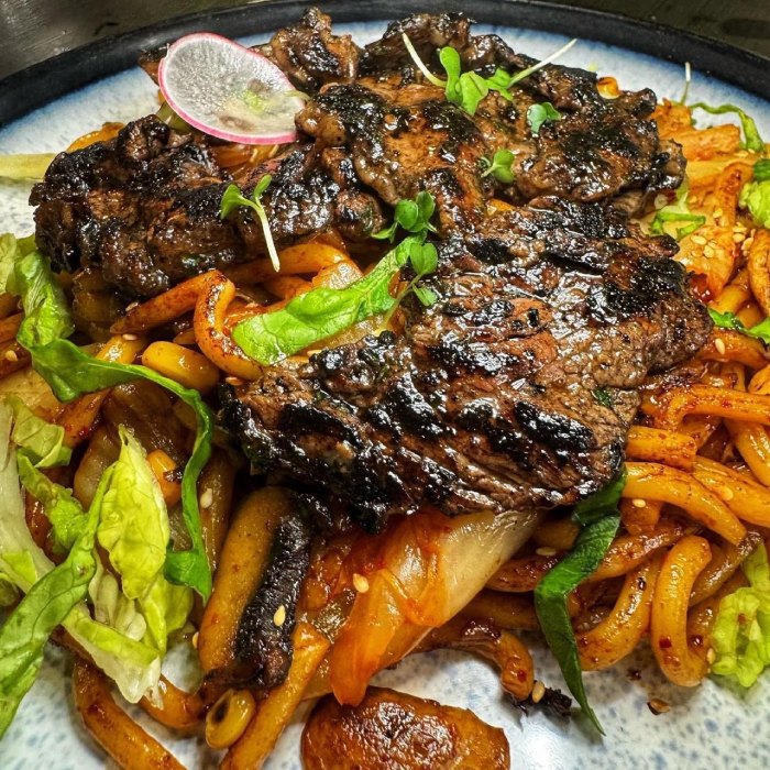 grilled beef over stir-fried noodles with vegetables served at Who’s 
Café 